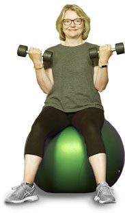 survivor of cancer on exercise ball with weights