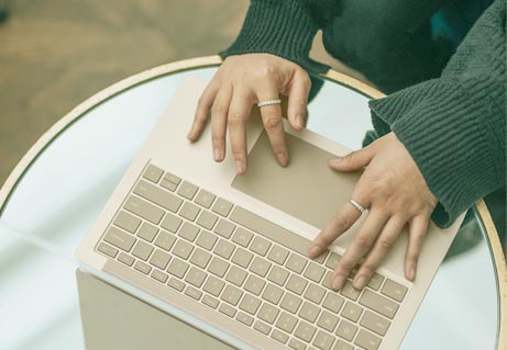 hands typing on a laptop