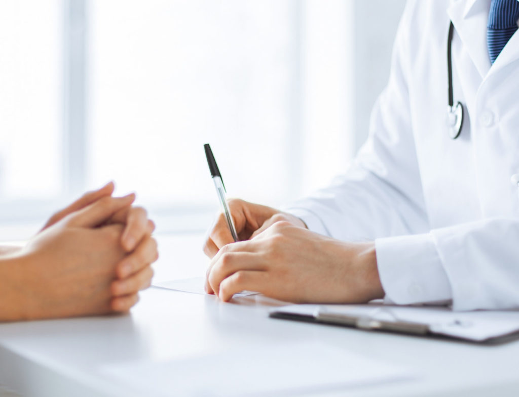 Close,Up,Of,Patient,And,Doctor,Taking,Notes