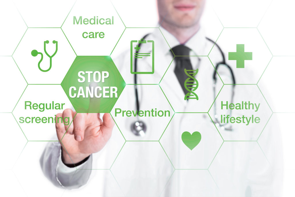 Cancer prevention and awareness concept with icons and words on screen and medical doctor touching a button
